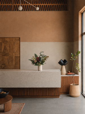 Modern interior with a neutral color palette, featuring a vase with flowers and decorative items on a counter in Vancouver Office