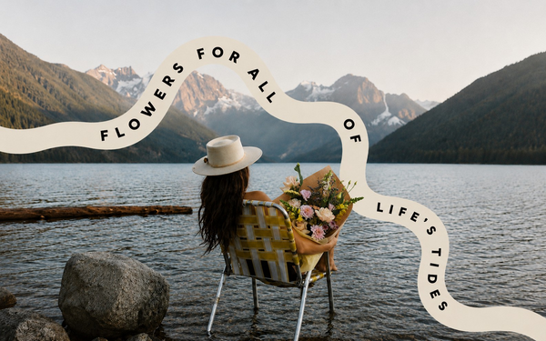 Person with a bouquet of flowers by a lake witha Vancouver mountains in the background, text overlay 'Flowers for all of life's tides'.